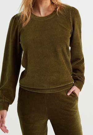 Haut en velours côtelé vert olive avec texture côtelée, manches longues et encolure ronde. Offrant un tissu doux et une coupe décontractée.