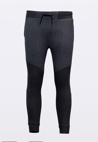 Fitted joggers in dark gray featuring a textured fabric, contrasting smooth dark panels, elastic waistband with drawstring, and tapered legs.