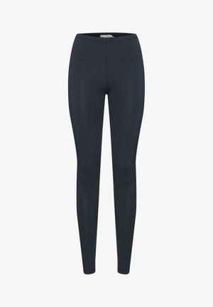 Námořnické modré legíny vyrobené z pružné a hladké látky. Mají vysoký pas a těsně přiléhající střih bez kapes nebo ozdob.