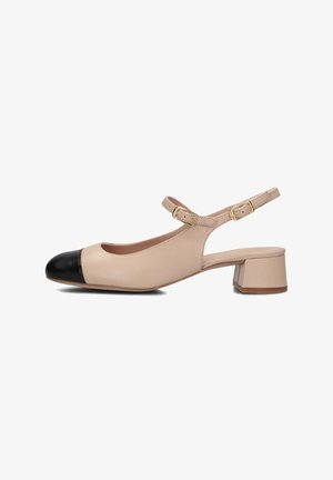 Beige leather slingback shoe with a black cap toe, ankle strap, gold buckles, and a low block heel. Smooth texture and minimal design.