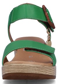 Green leather sandal with an adjustable strap and brown accent. Flat textured sole with ridged details; size marked as 37. Gold hardware detail.