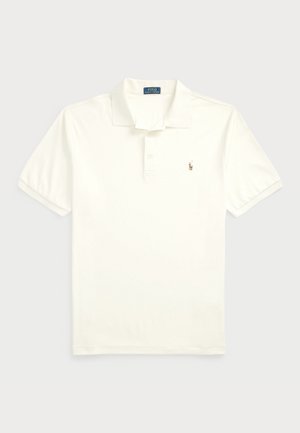 Baltas kokvilnas polo krekls ar klasisku apkakli, trīs pogām priekšpusē un mazu izšūtu logotipu kreisajā krūtī. Īsas piedurknes.