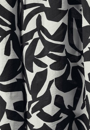 Tessuto bianco e nero con grandi e audaci motivi astratti a foglia. Texture morbida con una finitura liscia e una leggera lucentezza.