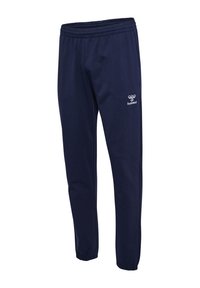 Marineblaue Jogginghose mit elastischem Bund, konischem Schnitt und Hummel-Logo auf dem linken Oberschenkel. Glatter Stoff ohne zusätzliche Verzierungen.