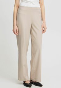 Beige kalhoty s širokými nohavicemi a hladkým povrchem a rovný střih. Pás je plochý a látka se jemně draped.
