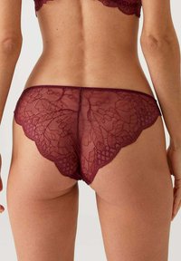 Bordeaux kantene ondergoed met een bloemenpatroon, gegolfde randen, semi-doorzichtig materiaal en een delicate textuur.