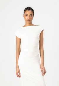 White, fitted off-shoulder dress in soft fabric, featuring a draped design, smooth texture, and a streamlined silhouette.
