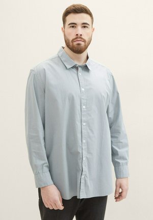 Light blue checkered long-sleeve shirt with a button-down collar, made of soft fabric, featuring a front button closure and cuff details.