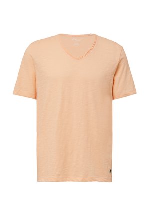 T-shirt à manches courtes, encolure en V, de couleur pêche clair. Tissu doux et texturé avec une légère variation. Étiquette sur l'ourlet latéral.