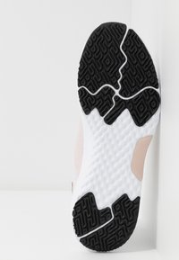 Suola di scarpa sportiva con un motivo in gomma nera testurizzata, intersuola bianca con un design ondulato e dettagli rosa chiaro sui lati.
