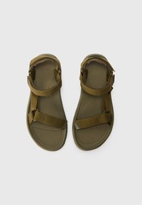 Olivengrønne sandaler med justerbare nylonremmer, en textured sål og en formet gummisål for stabilitet.