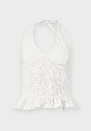 Haut blanc sans manches à col licou avec texture œillet, taille froncée et ourlet volanté.