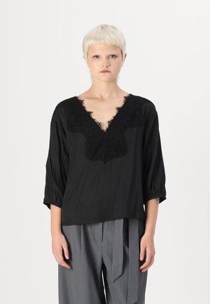 Black blouse featuring a deep V-neck, intricate black lace detailing, and three-quarter sleeves with gathered cuffs. Soft, lightweight fabric.