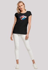Black short-sleeve t-shirt featuring a colorful graphic print of a superhero in motion, with "FLASH" text integrated into the design.