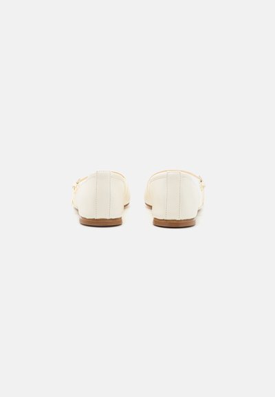 White leather ballet flats with a rounded toe, minimal stitching, and a small brown heel. Smooth texture, no visible patterns or accents.