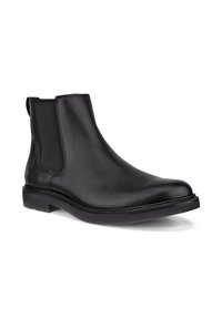Botte Chelsea en cuir noir avec panneau latéral élastique et semelle basse empilée, présentée sous un léger angle sur fond blanc.