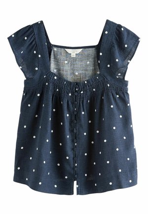 Granatowa lniana bluzka w białe grochy, z krótkimi bufiastymi rękawami, zapięcie na guziki z przodu oraz marszczony dekolt.