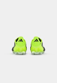 Neon yellow and black Adidas Copa soccer cleats viewed from the back on a white background.