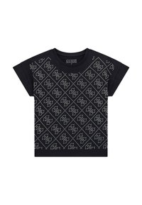 T-shirt en coton noir à manches courtes, avec un motif en losanges de clous argentés sur le devant. Étiquette du logo visible au niveau du cou.