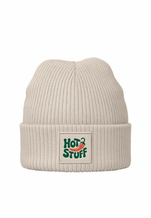 Knit beanie in light beige with a folded cuff. Features a green and red "HOT STUFF" logo on a cream label. Soft texture, ribbed design.