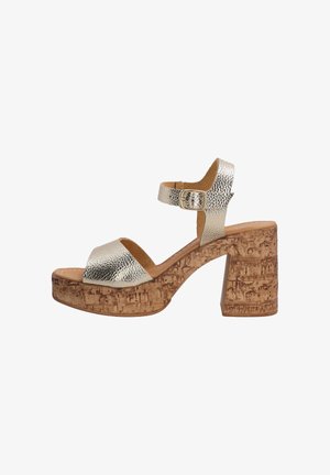 Metallic silver platform sandal featuring a chunky cork heel, ankle strap with buckle, and textured upper. Open toe design with cushioned insole.