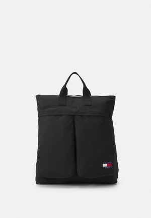 Sac fourre-tout en nylon noir avec deux poches avant, deux anses supérieures et une fermeture éclair. Comprend un patch logo en bas à droite.