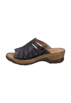 Navy leather slide sandal with open toe, cut-out design, decorative hardware, cushioned footbed, and textured tan wedge sole.