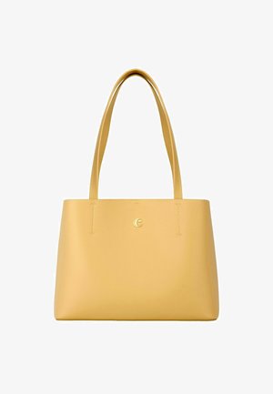 Gul lædertaske med lange håndtag og et lille gult "C"-logo centreret nær toppen foran.
