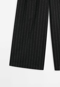 Black pinstripe trousers featuring a wide-leg design, soft texture, and subtle metallic thread accents for added detail.