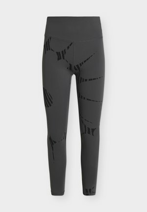 Colanți gri închis cu talie înaltă și detalii abstracte negre, mulați cu un finisaj neted și picioare lungi.