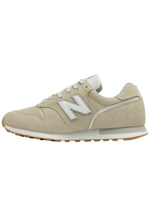 Beige New Balance suede and mesh sneaker with white "N" logo, laces, and gum rubber sole, shown from the side on a white background.