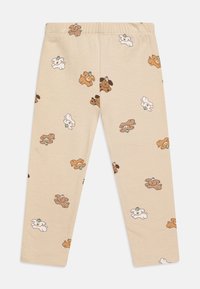 Beige leggings, joissa on toistuva kuvio karhuleluista ruskeana, valkoisena ja vaaleanruskeana, valmistettu pehmeästä puuvillamateriaalista.