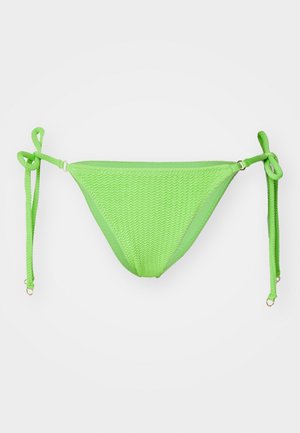 Groene gebreide bikini-onderbroek met striksluitingen aan de zijkant. Kenmerkt zich door een gestructureerd zigzagpatroon en accenten in goudkleurig metaal.
