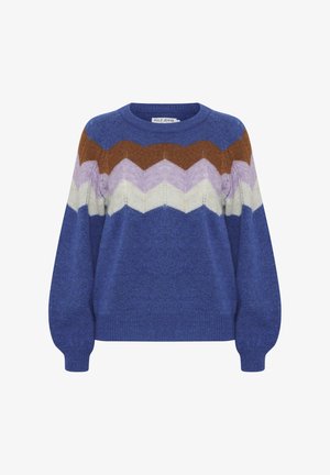 Modrá svietniková svetrová kombinácia z vlny s chevronovým vzorom v hnedej, purpurovej, bielej a svetlomodrej farbe. Okrouhly výstrih a balónové rukávy, s rebrovanými manžetami.