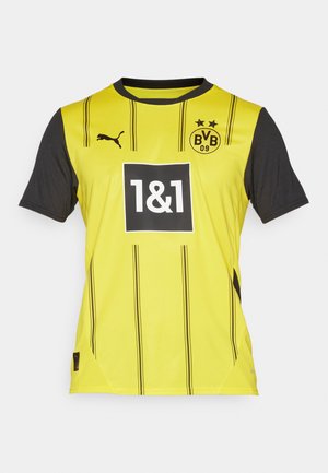 Gul og sort kortærmet sports trøje med lodrette striber, med et logo, nummer 1&1 i en boks, og Puma branding på skulderen.