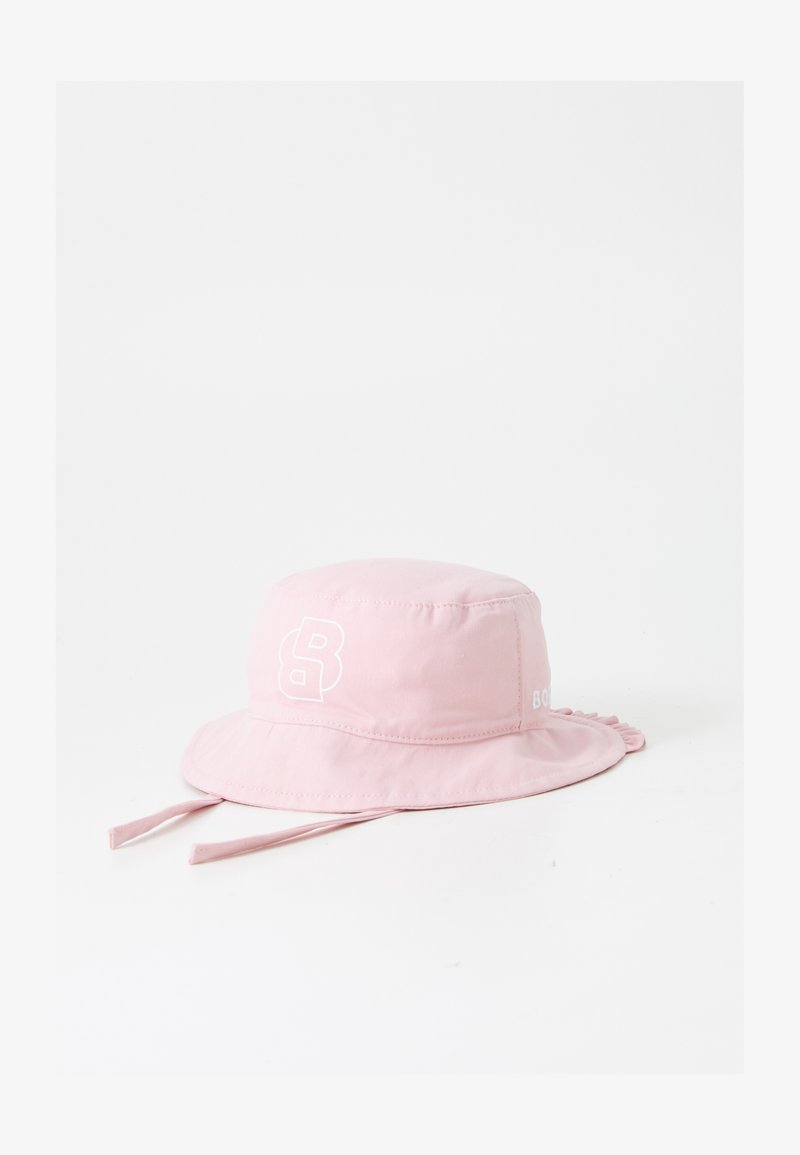 Pink bucket hat made of soft fabric, featuring a white logo and drawstring accents, with a wide, flat brim for sun protection.