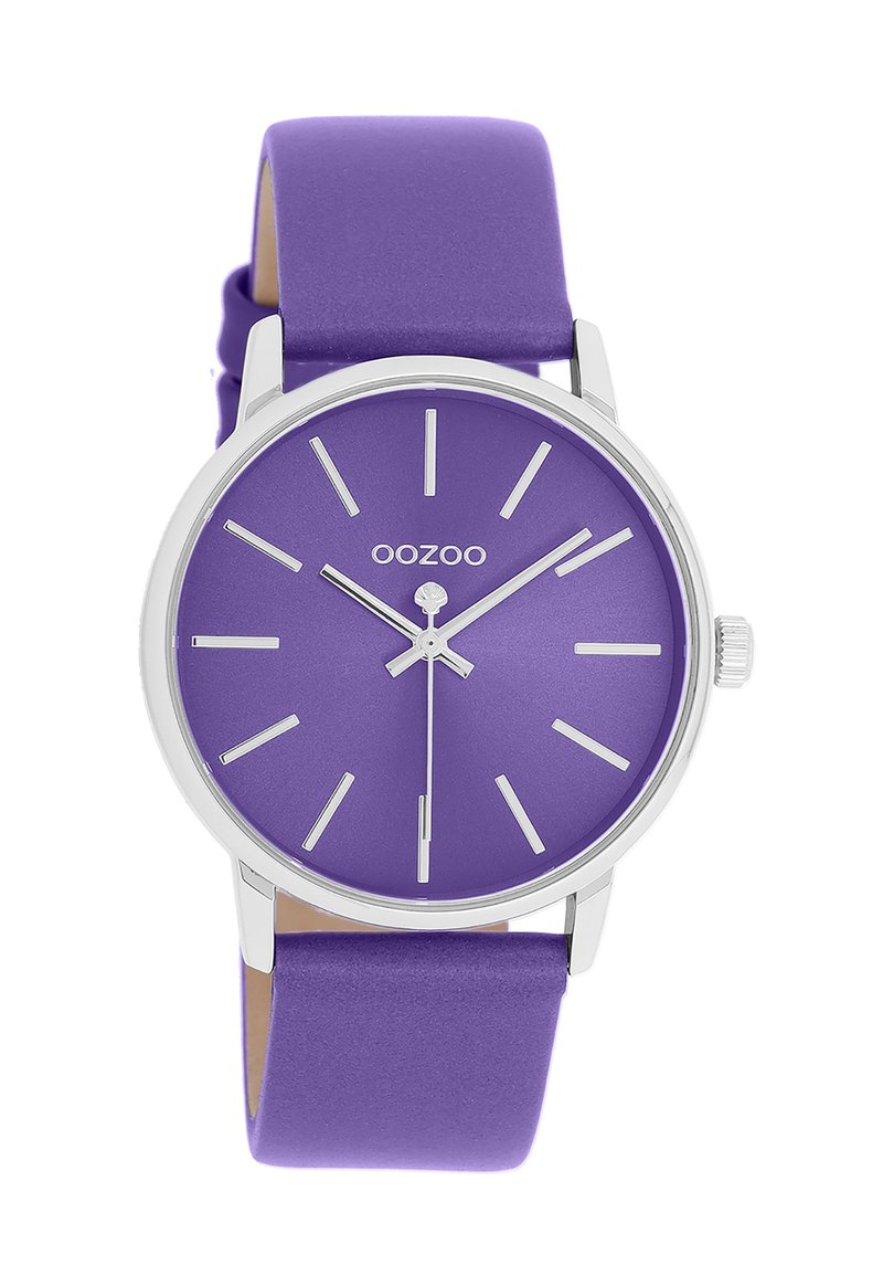 Purple watch with a matte dial, silver accents, simple hour markers, and a smooth purple silicone strap. Overall round shape.