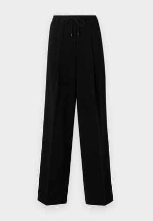 Black trousers with a relaxed fit, pleated front, elastic waistband, and drawstring. Fabric appears smooth with a slight sheen.