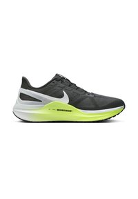 Zapatilla de correr Nike con parte superior de malla negra, acentos en blanco y verde, superficies texturizadas y una entresuela amarilla para mayor amortiguación y soporte.