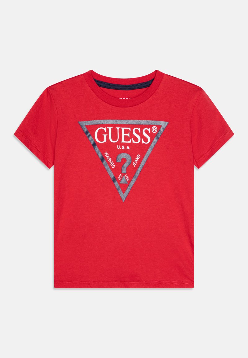 Red cotton t-shirt featuring a triangular grey graphic with "GUESS U.S.A." and "? 1981" text, short sleeves, and a crew neckline.