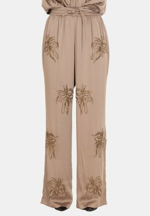 Pantaloni beige a gamba larga con vita elastica, con motivi ricamati floreali marroni simmetrici sul davanti e sui lati.