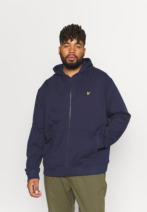 Marinblå zip-hoodie i bomullsblandning, med ficka fram, ribbade ärmslut och en liten gul logotyp på vänster bröst.