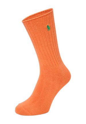 Orange gestreifte Socken aus einem weichen Material, mit einem grünen Logo an der Seite und einem runden Zehendesign.