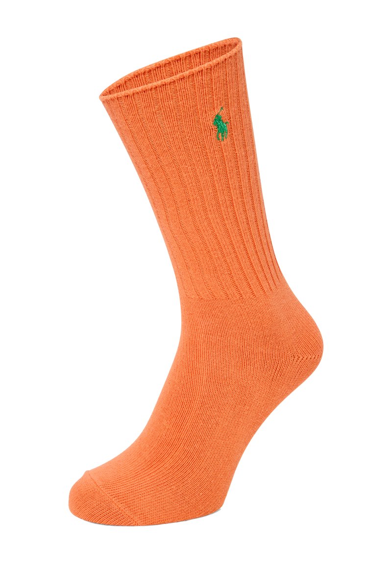 Oranje geribde sokken van een zachte stof, met een groen logo aan de zijkant en een ronde teenontwerp.