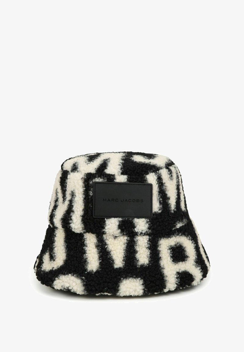 Zwarte en witte fleece bucket hat met opvallende letters, een gestructureerde vorm en een merkafgebonden zwarte leren patch aan de zijkant.
