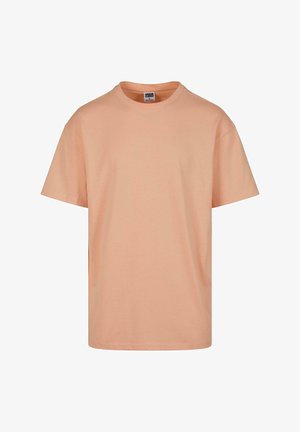 T-shirt en coton pêche avec un col rond, des manches courtes et une coupe décontractée, arborant un design simple et uni.