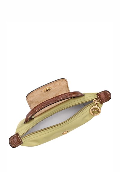 Green canvas pouch with brown leather accents, top zipper opening, and gold hardware. Features a textured handle and logo charm.