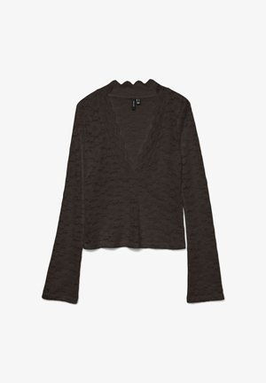 Pruun pikkade varrukatega särk lainelise tekstuuriga mustriga, V-kaeluse ja kaeluse ning mansettide laineliste servadega. Lühendatud mudel.