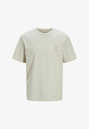 Ανοιχτό μπεζ βαμβακερό t-shirt με στρογγυλή λαιμόκοψη. Διαθέτει ένα μικρό λογότυπο φοίνικα σε ανοιχτό καφέ στην αριστερή περιοχή του στήθους. Κοντά μανίκια.