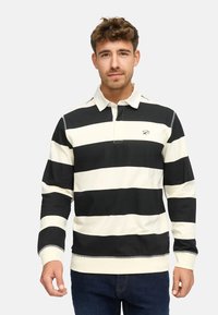 Polo a maniche lunghe a righe bianche e nere con colletto, dotato di un logo sul petto e polsini a coste. Adatto per un abbigliamento casual.